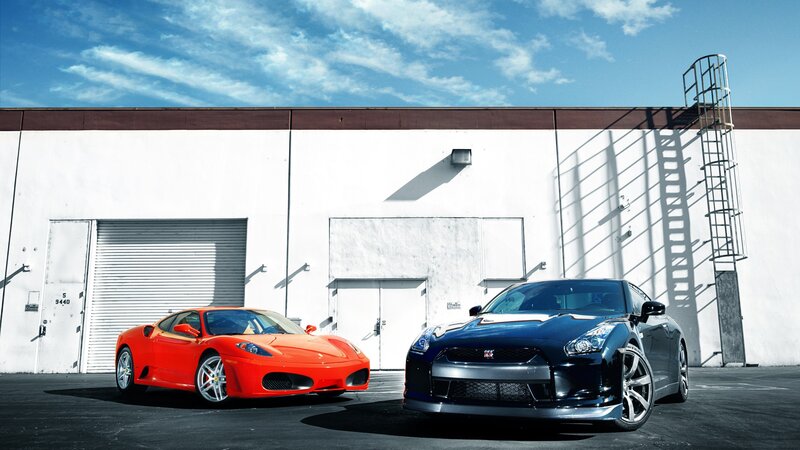 Two sports cars parked outside