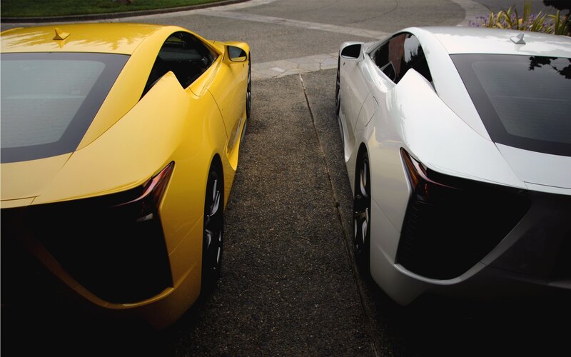 Two sports cars parked side by side