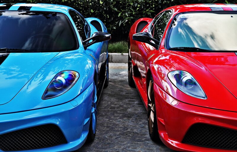 Two sports cars parked side by side