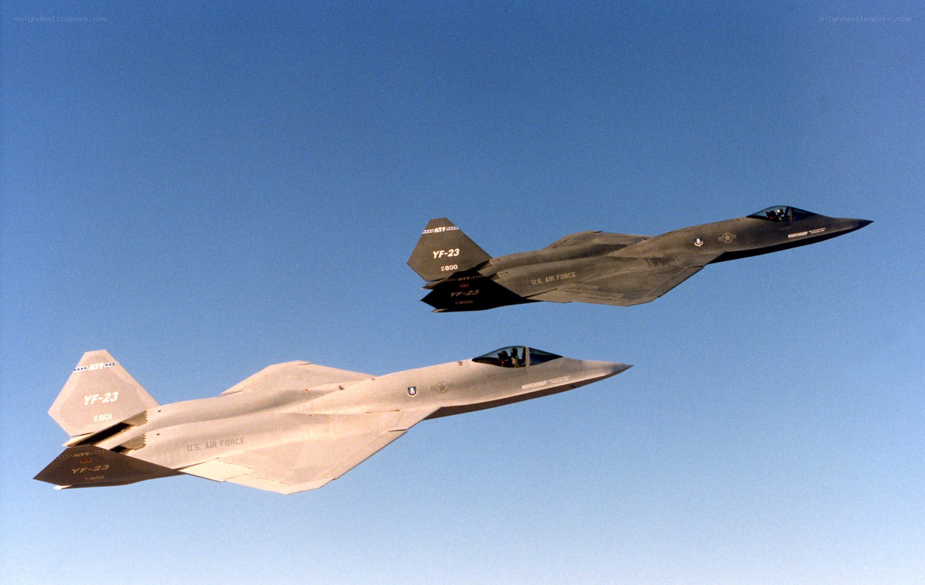 Two stealth fighter jets in flight