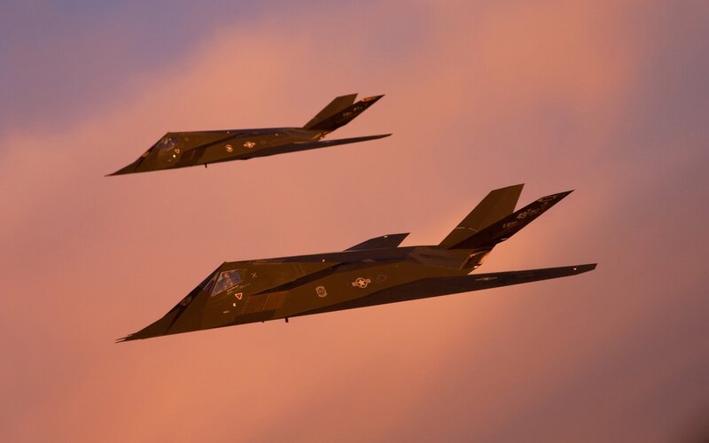 Two Stealth Fighter Jets — Orange