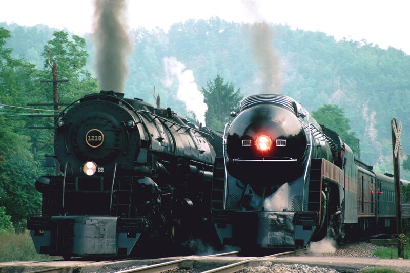 Two steam locomotives on tracks
