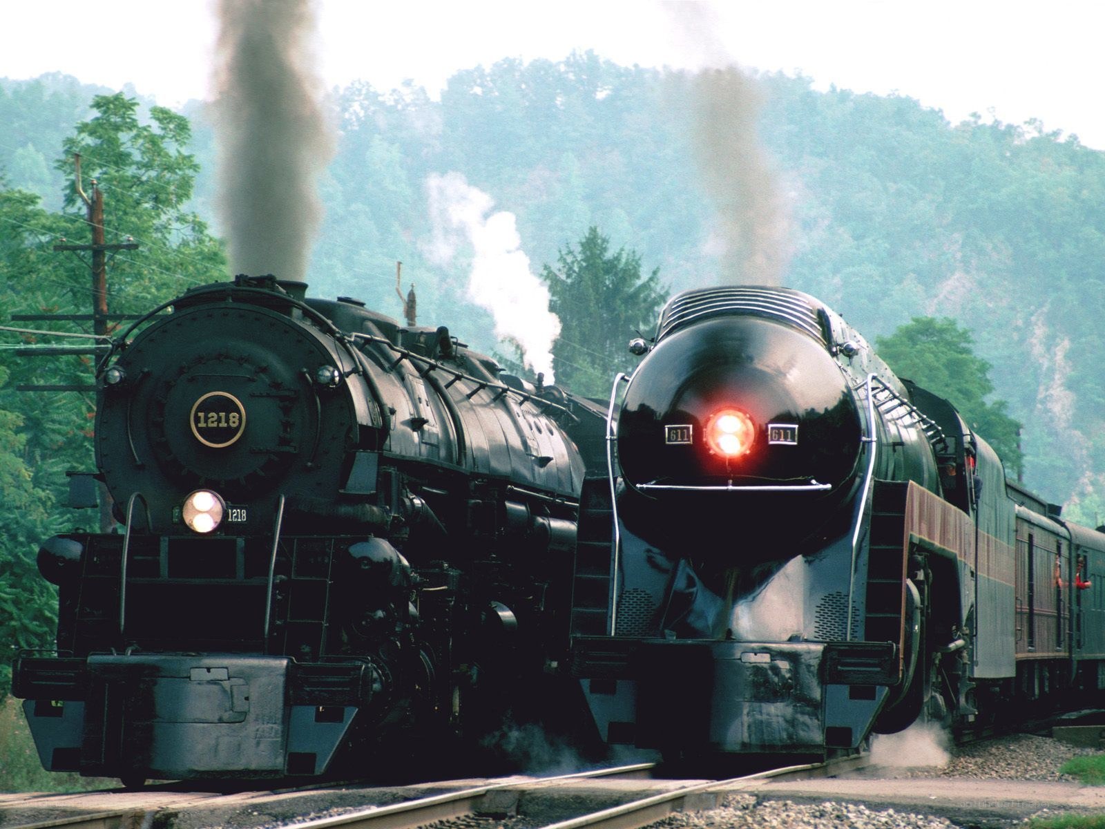 Two steam locomotives on tracks