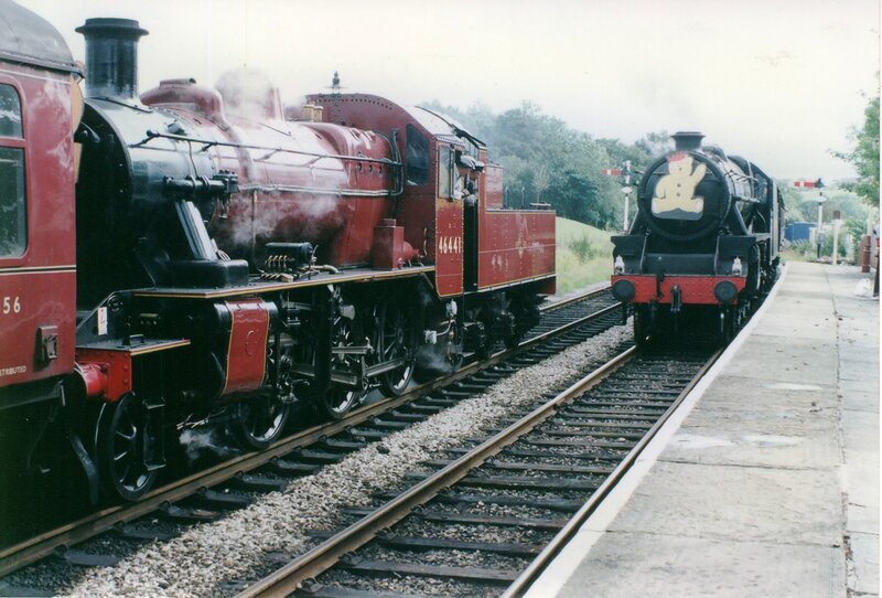 Two steam trains at a station