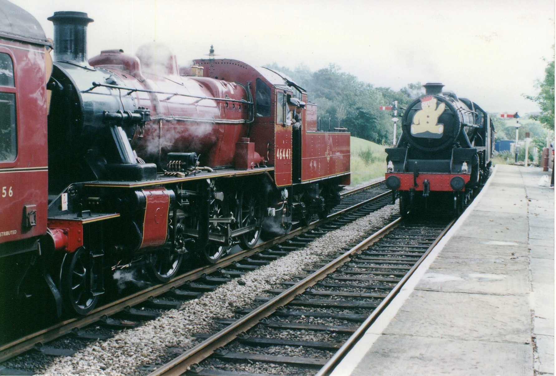 Two steam trains at a station