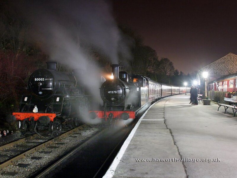 Two steam trains at night