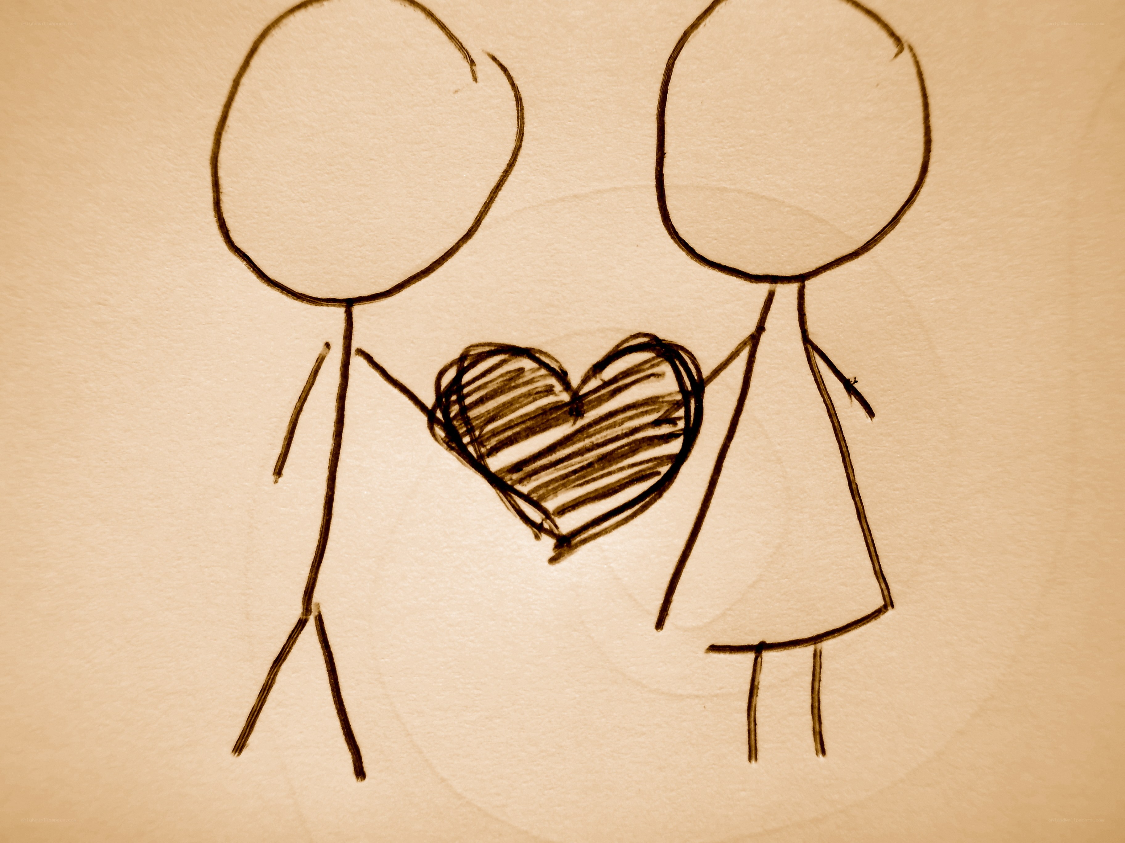 two stick figures holding a heart