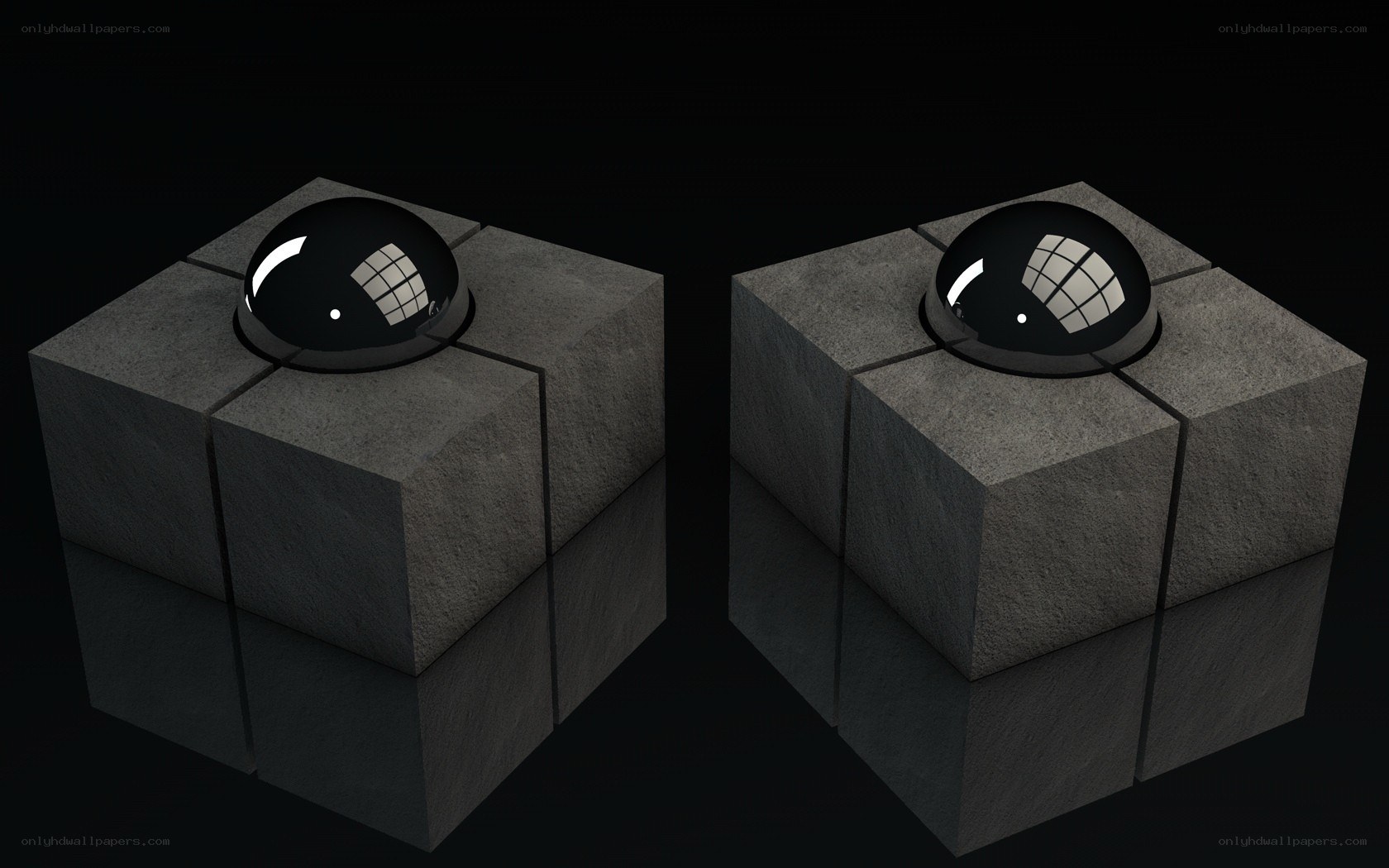two stone cubes with black spheres