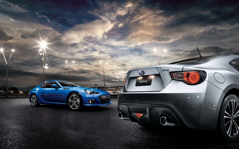 Two Subaru BRZ cars at night