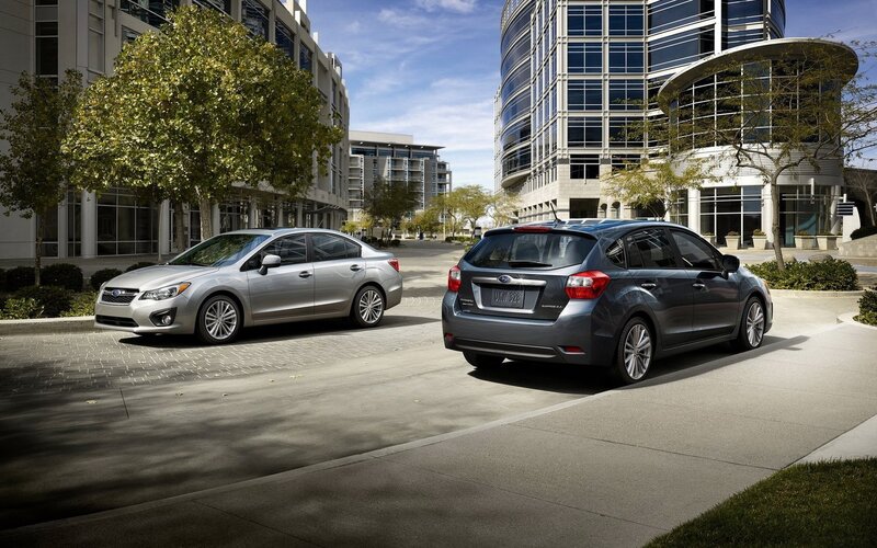 Two Subaru cars in a city