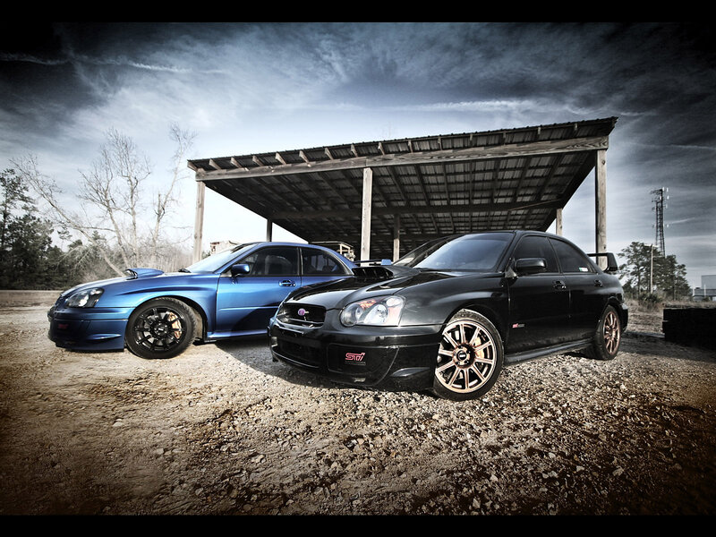 Two Subaru STI cars parked