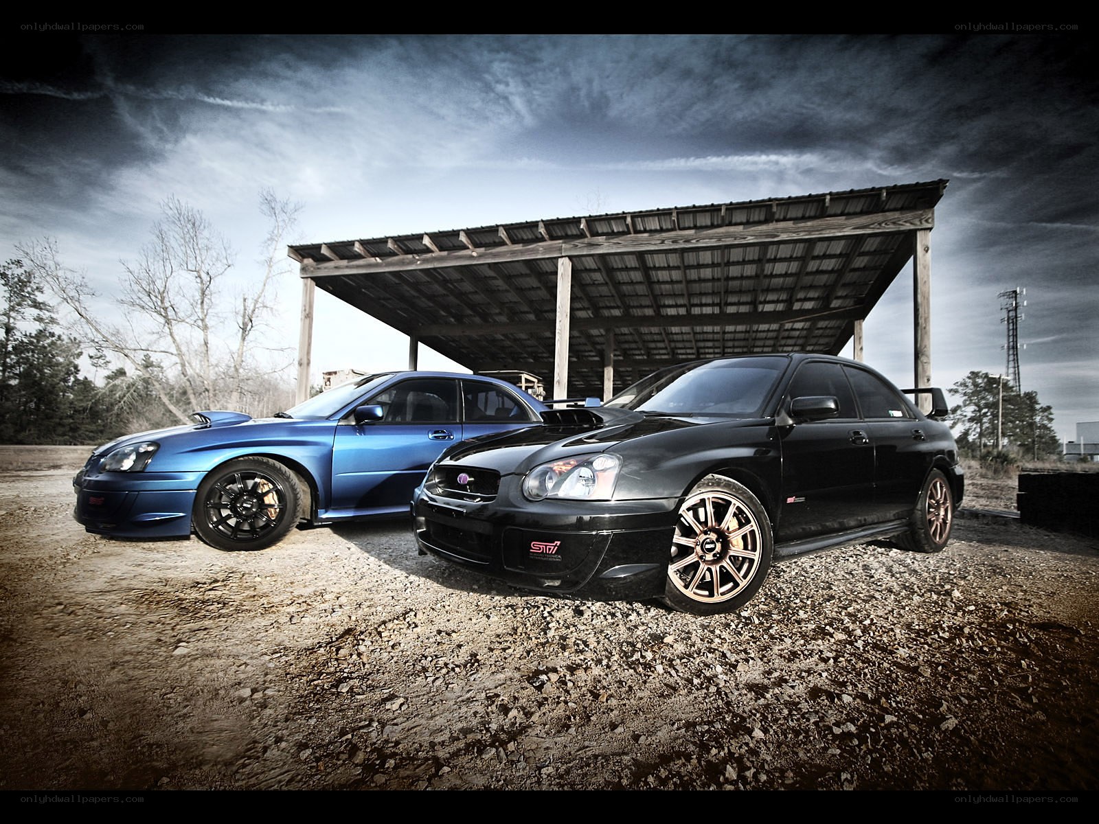 Two Subaru STI cars parked