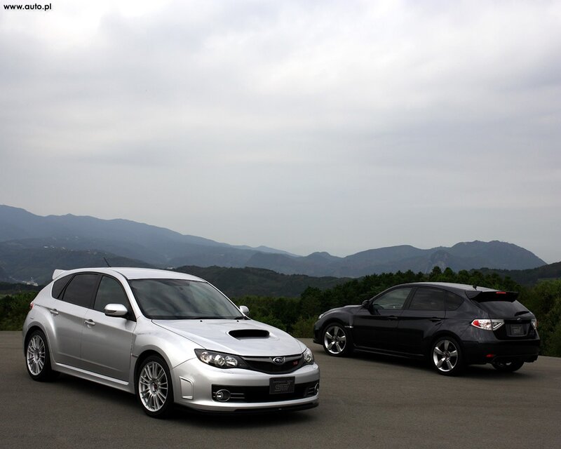 Two Subaru WRX STI cars on a mountain road