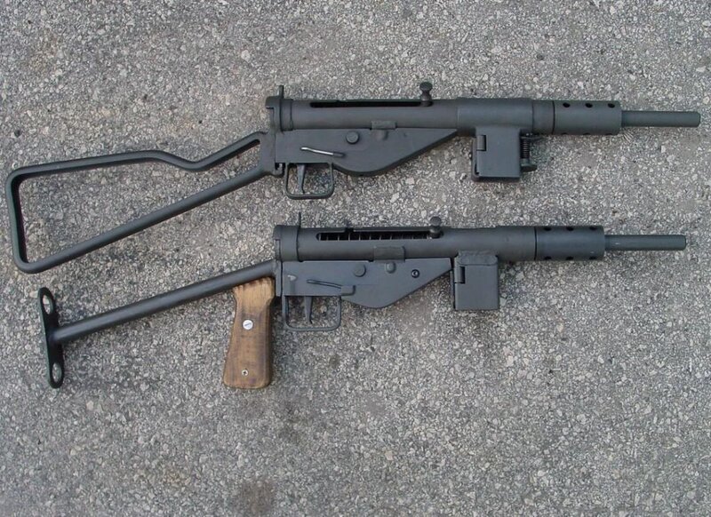 Two submachine guns on pavement