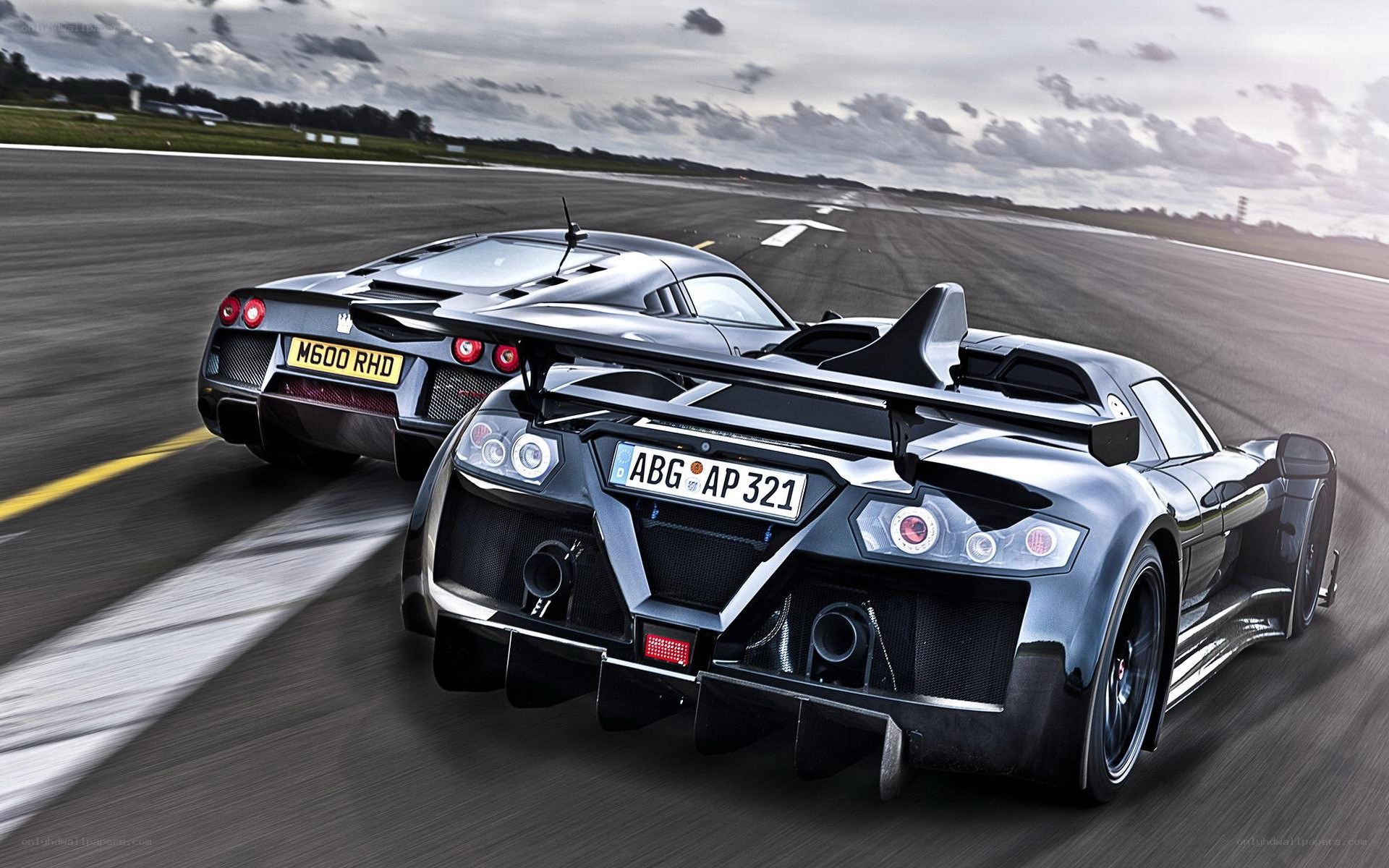 Two supercars racing on a track