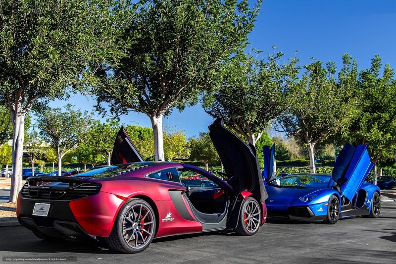 Two supercars with doors open