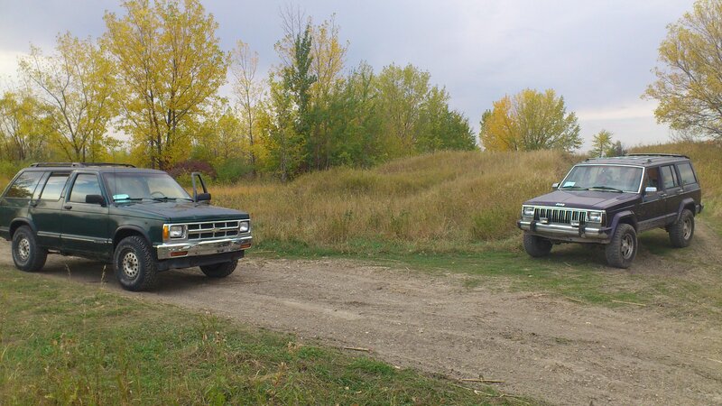 Two Suvs in Field