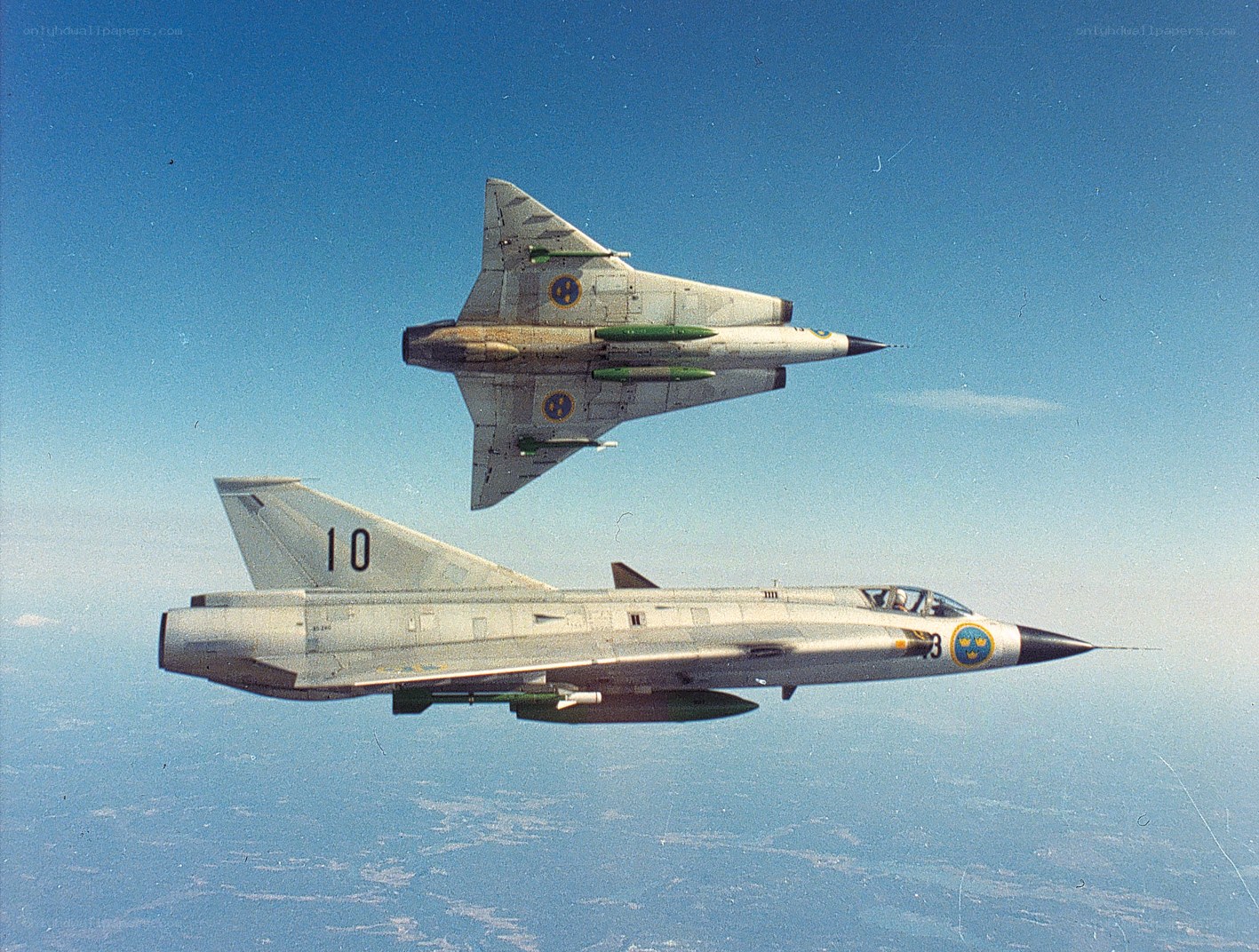 Two Swedish fighter jets in flight
