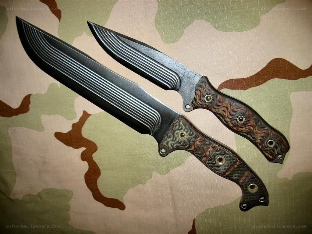 Two tactical knives on camouflage