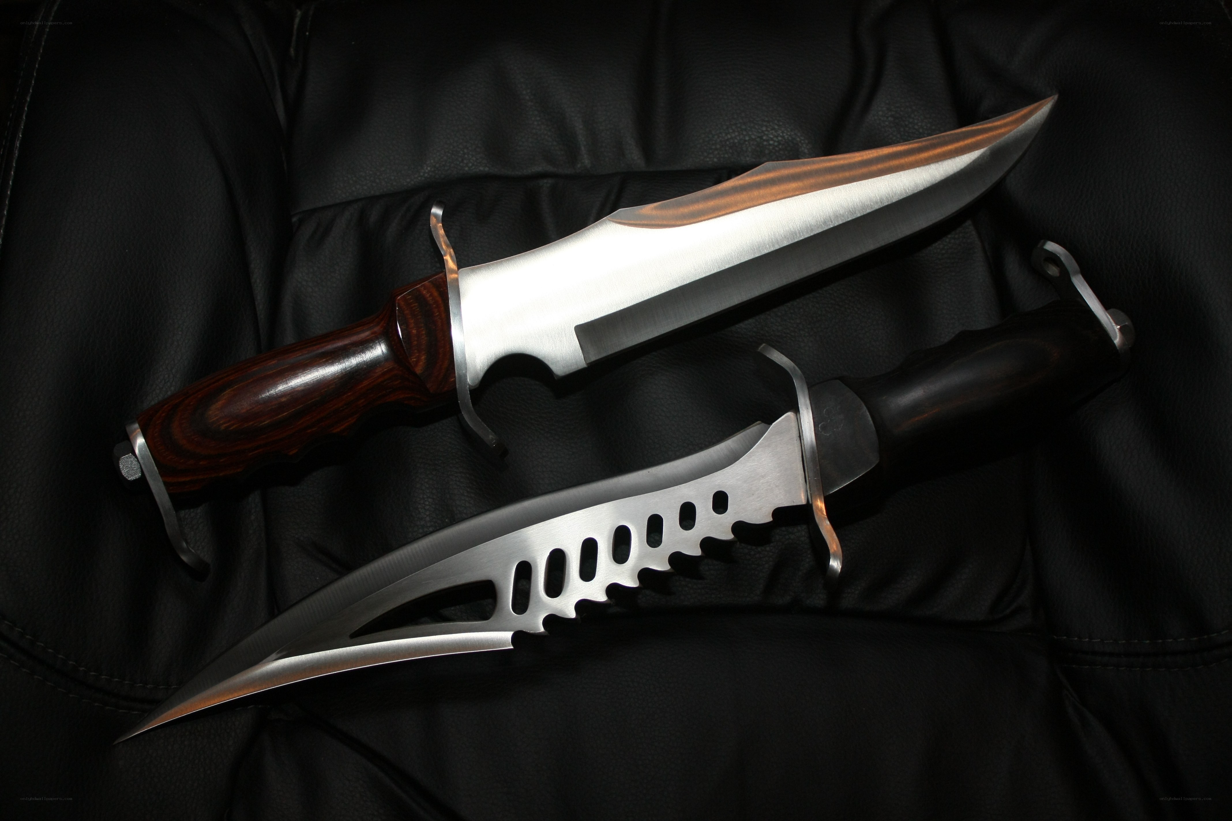 Two tactical knives on leather