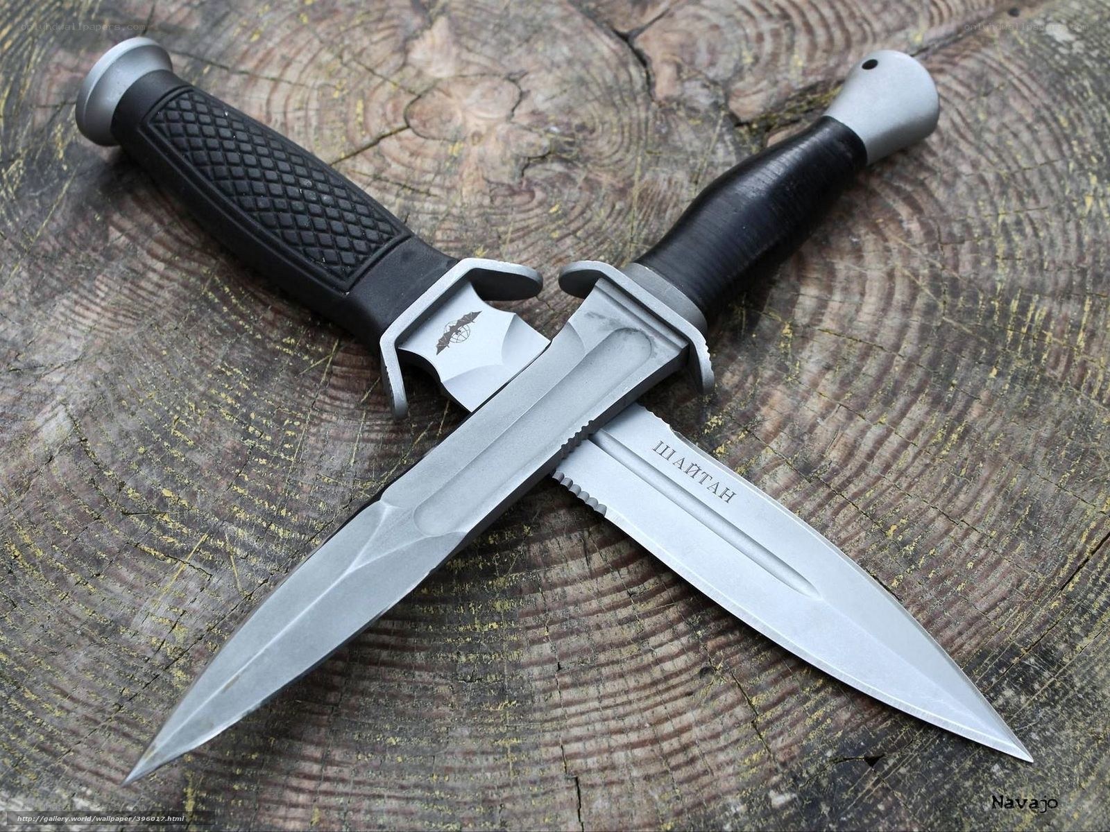 Two tactical knives on wood