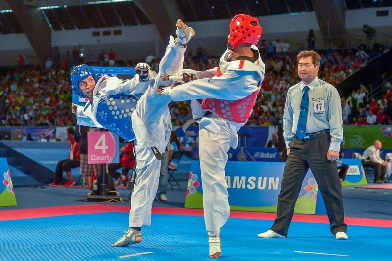 Two Taekwondo Fighters — Blue, Competitive, Photograph, Referee, Crowd, Blue Mat