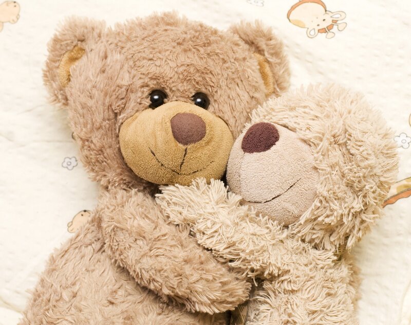 two teddy bears hugging