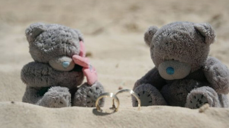 Two Teddy Bears on Sand