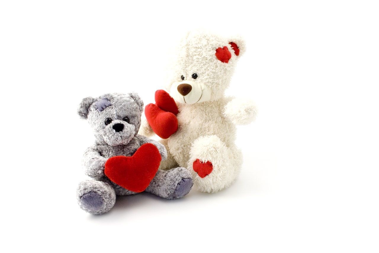 Two teddy bears with hearts