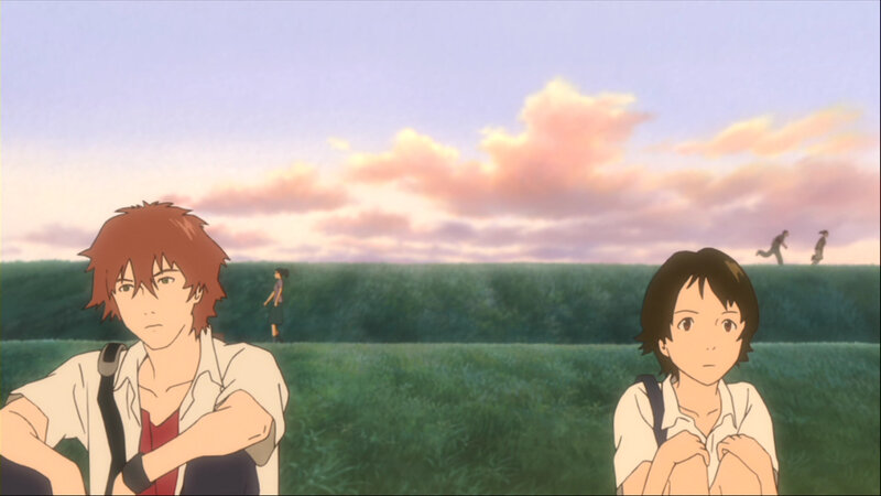 two teens in a field at sunset