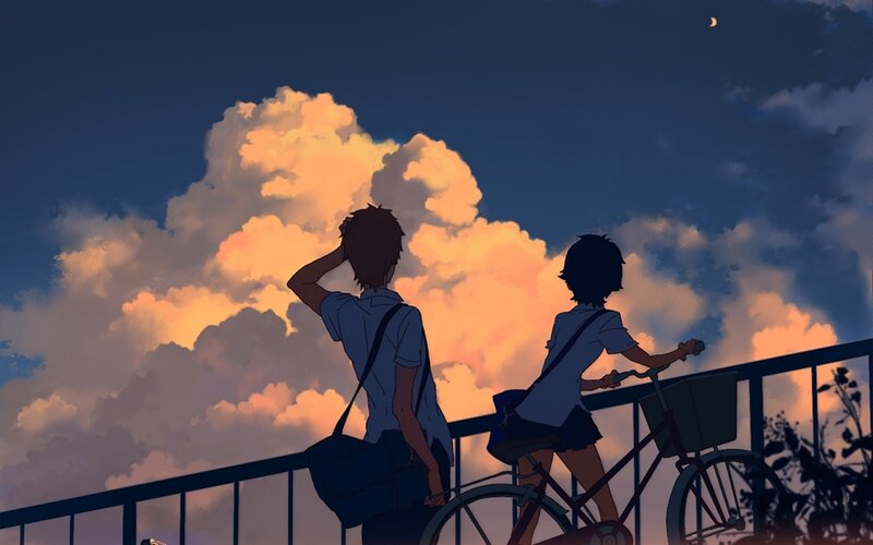 Two teens on a bridge at dusk