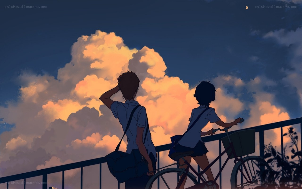 Two teens on a bridge at dusk