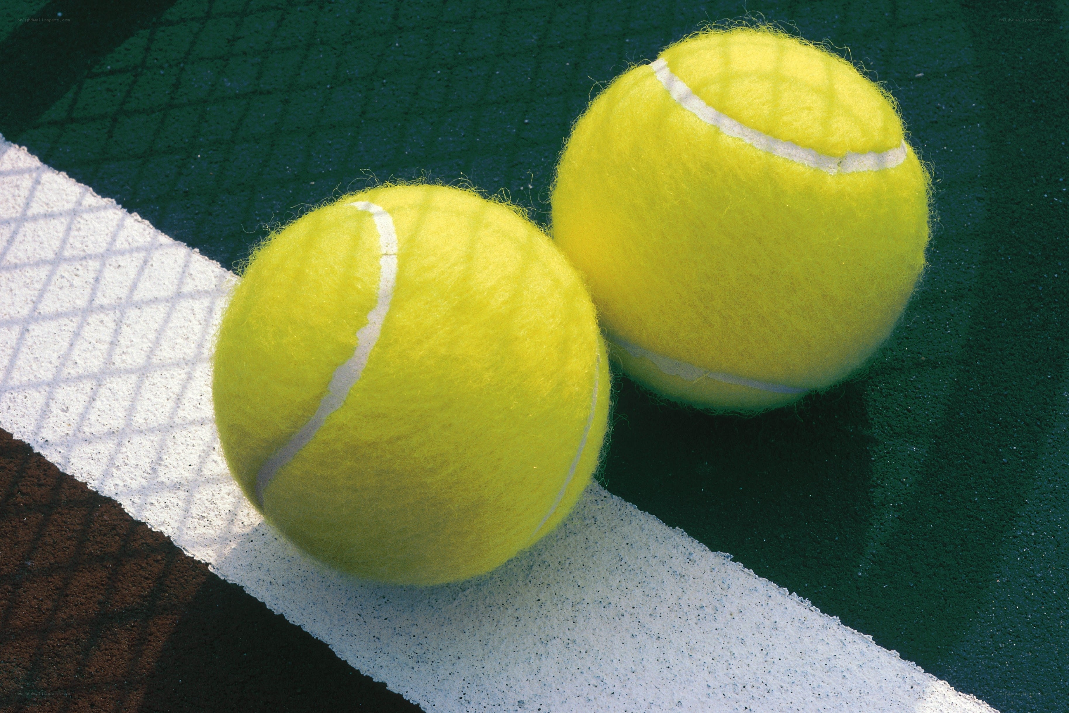Two tennis balls on a court