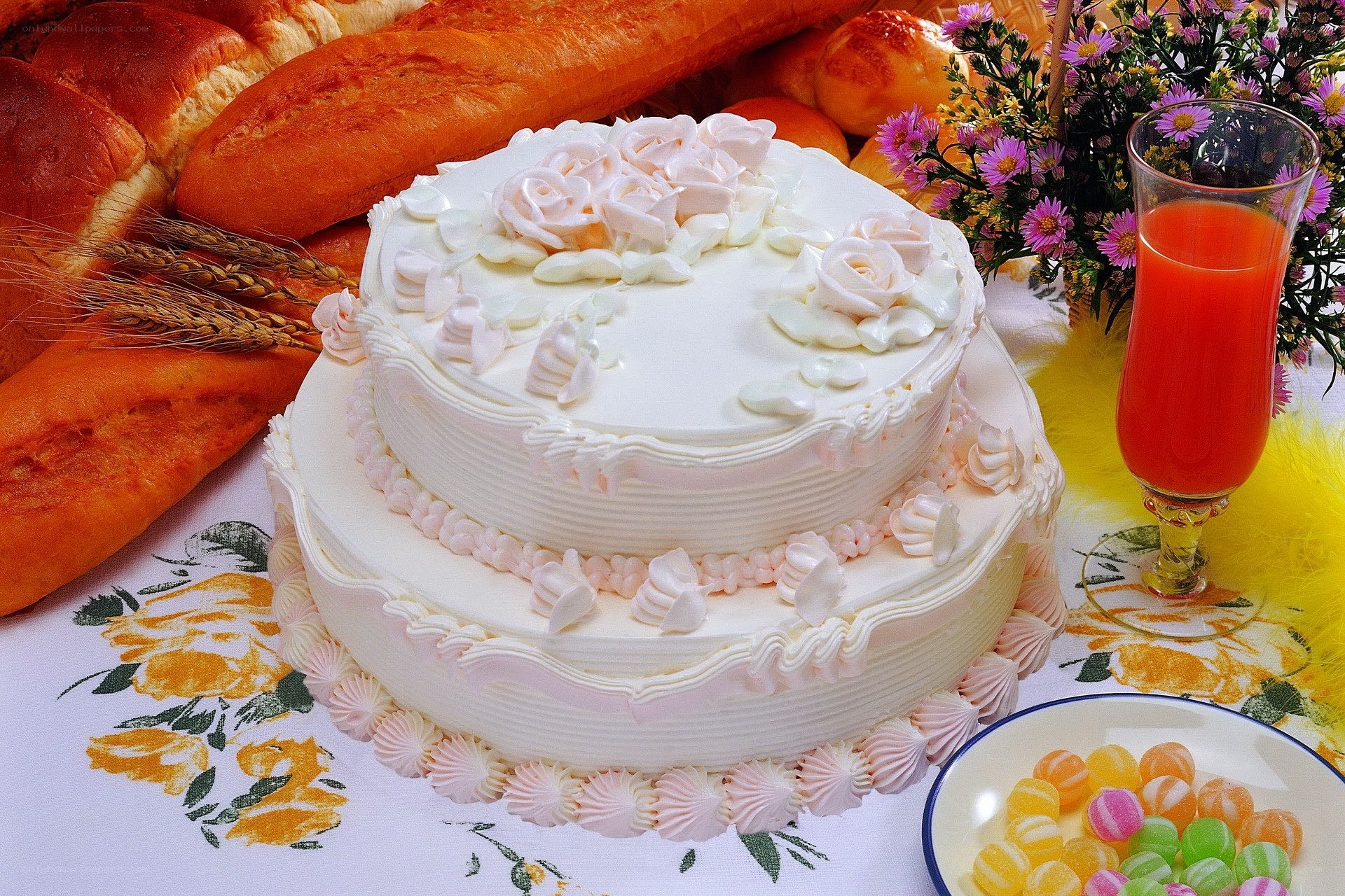 Two-tiered cake with bread and flowers