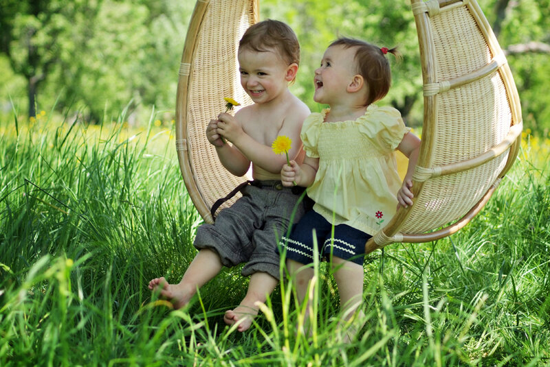 Two Toddlers in Wicker Chair