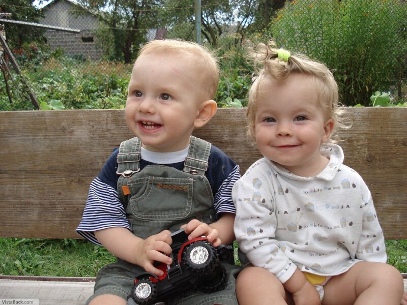 Two toddlers on a bench