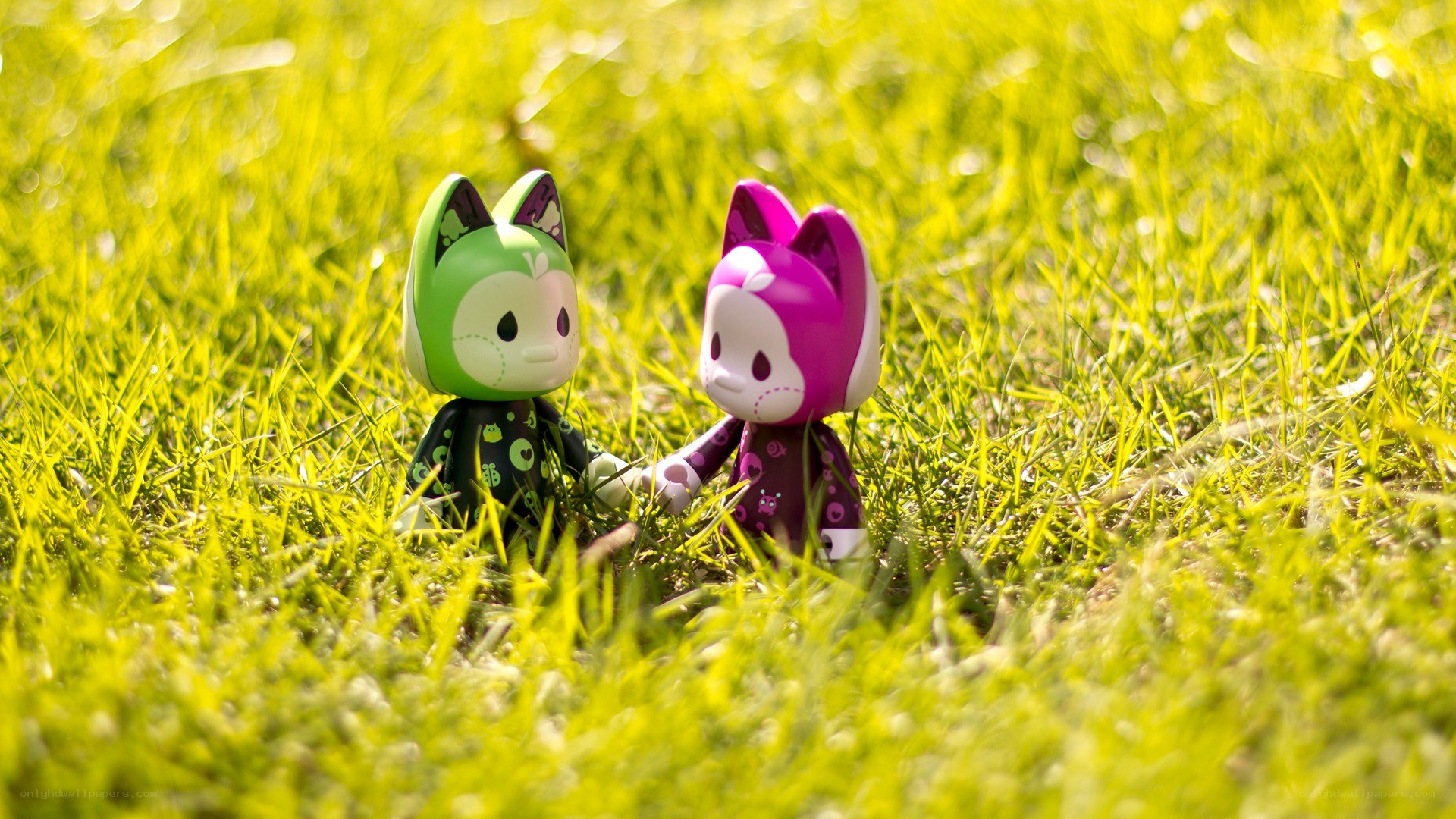 Two toy figures in grass