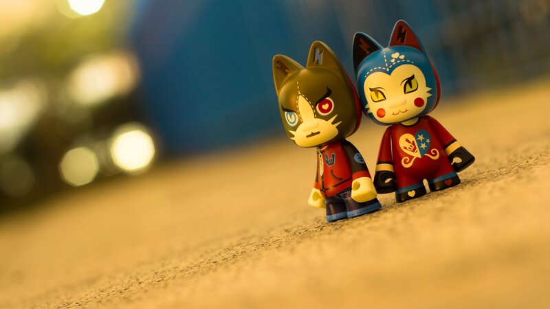 Two toy figures on pavement