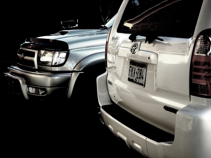 Two Toyota SUVs at night