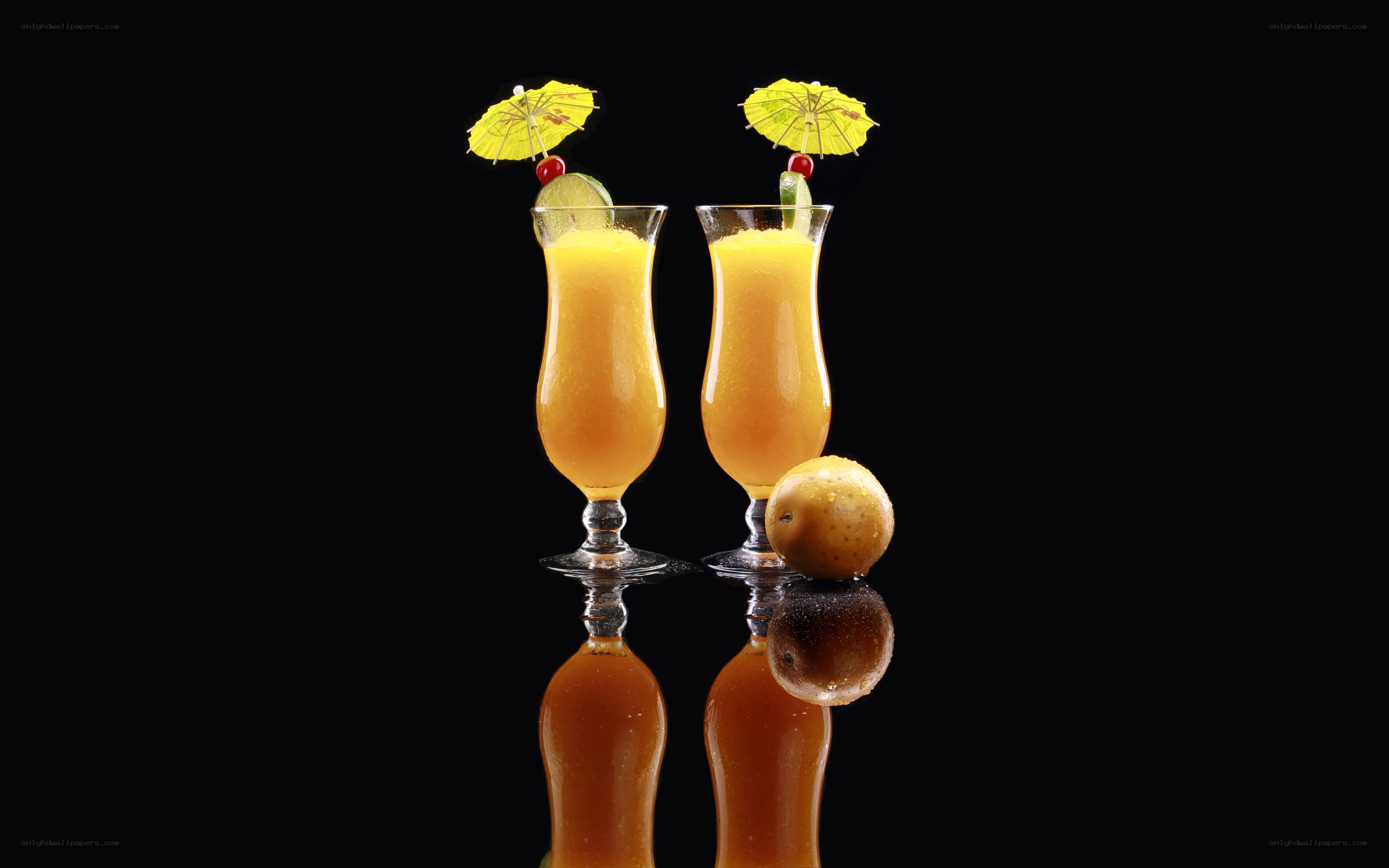 Two tropical drinks with fruit
