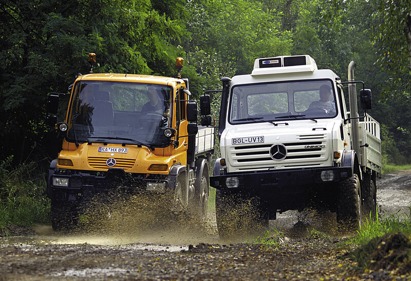 Two trucks on a muddy road