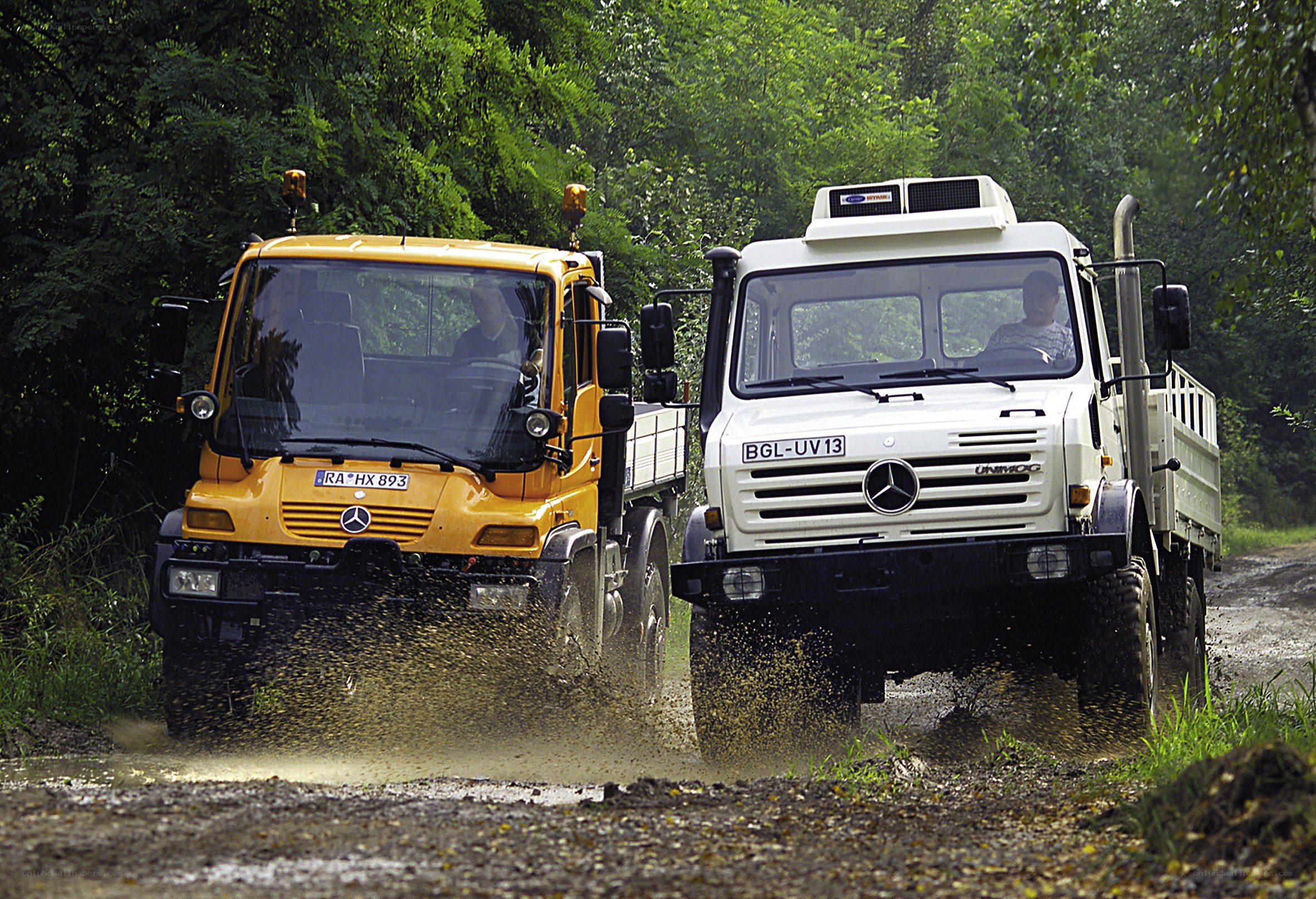 Two trucks on a muddy road