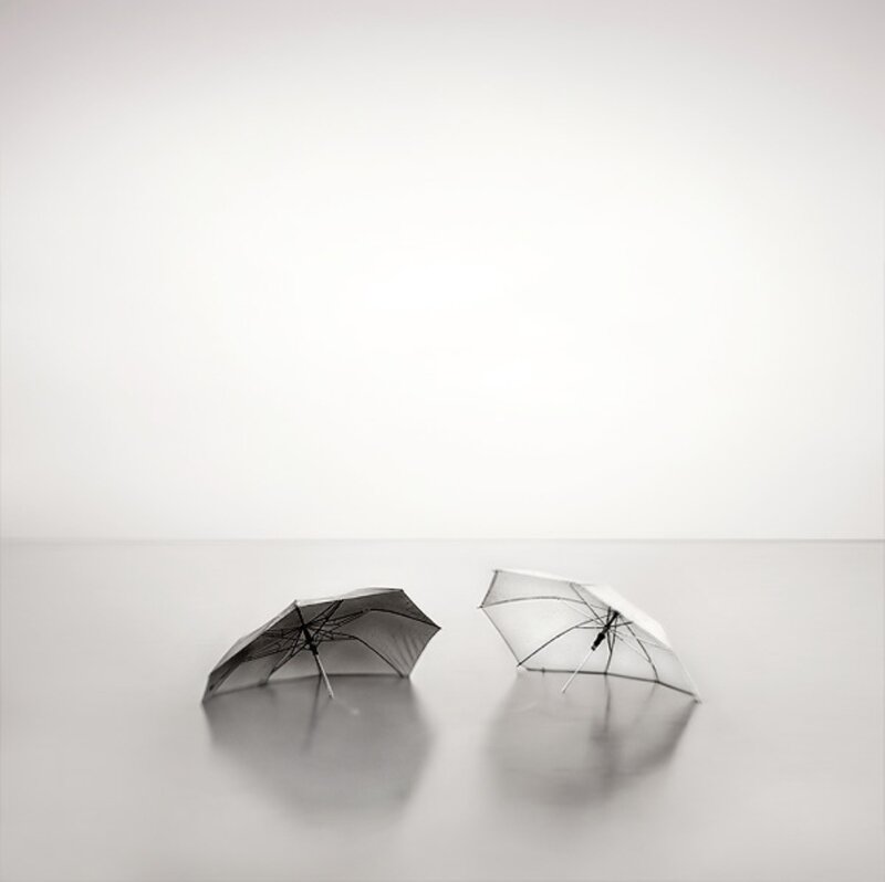 Two Umbrellas on Wet Surface