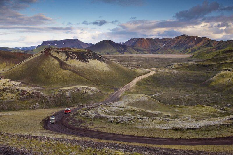 Two Vehicles on Dirt Road