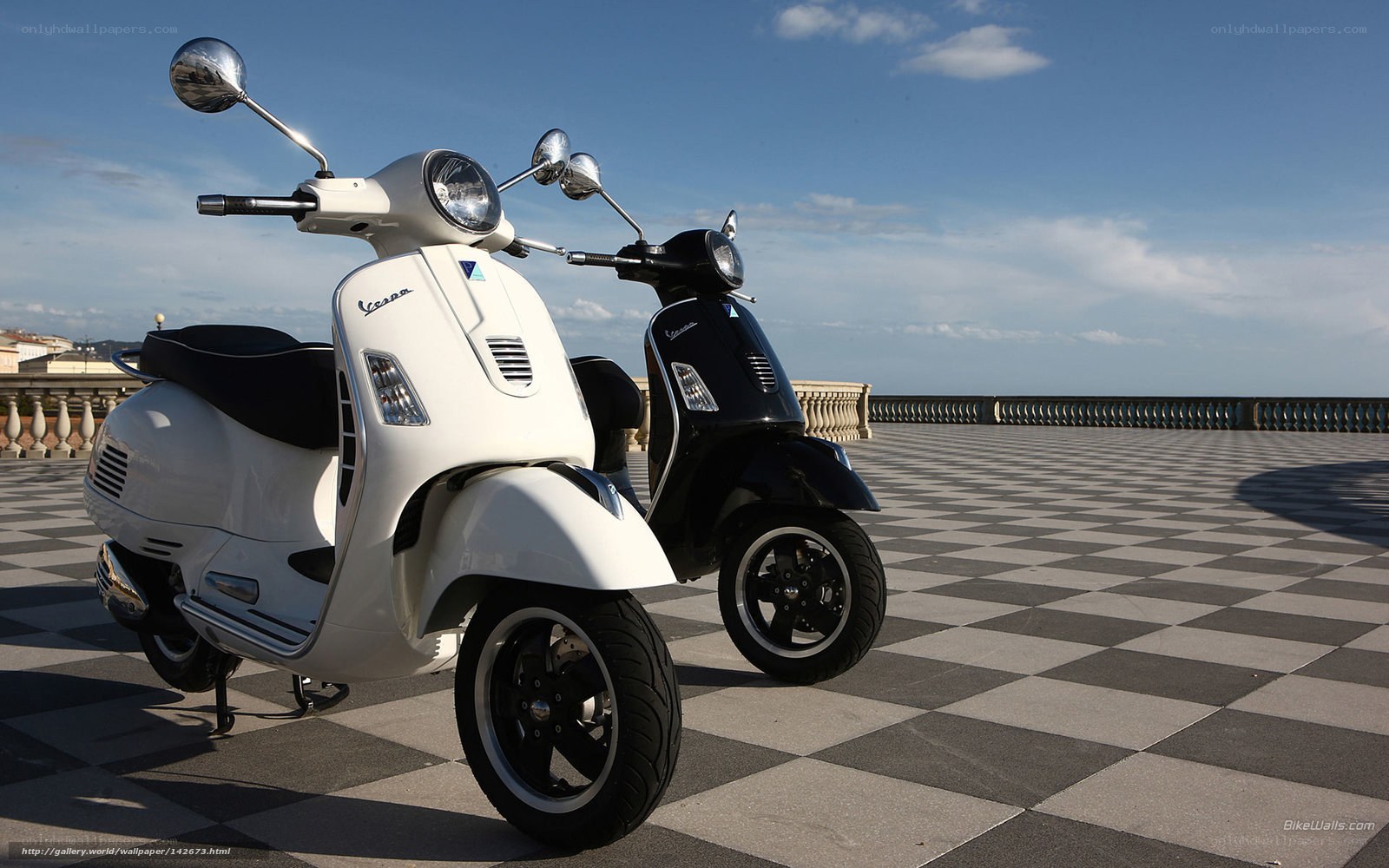 Two Vespa scooters on a terrace