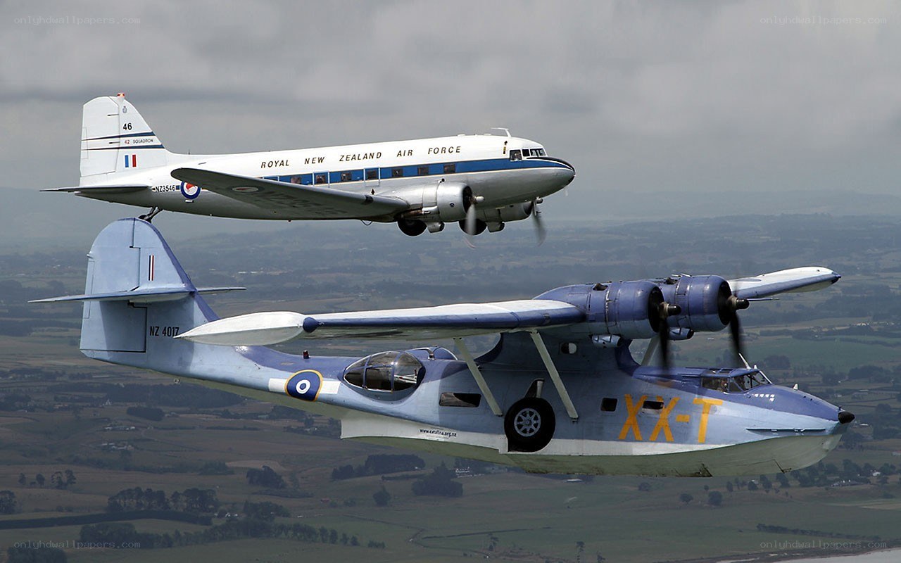 Two vintage aircraft in flight