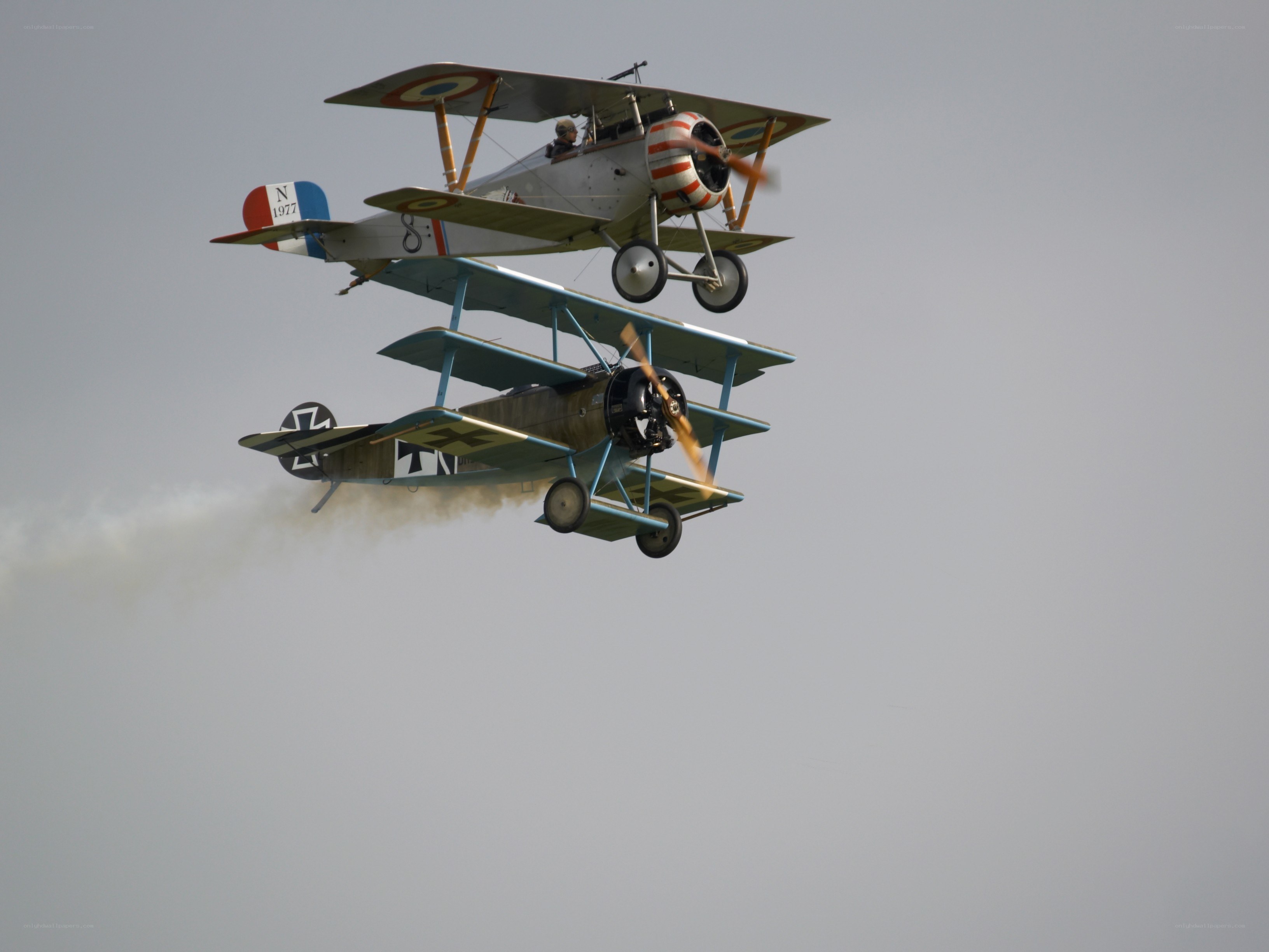 Two vintage biplanes in flight