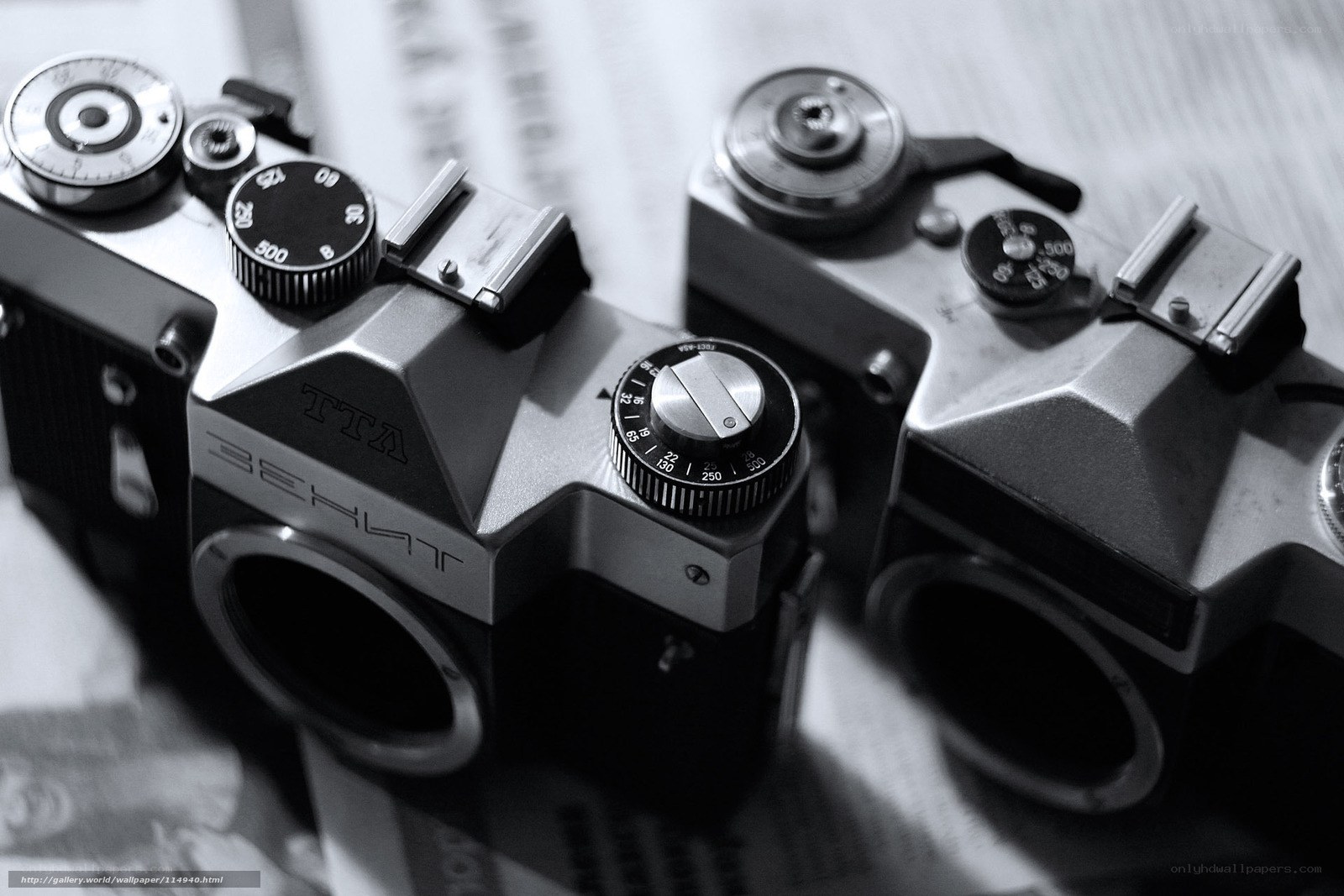 Two vintage cameras on newspaper