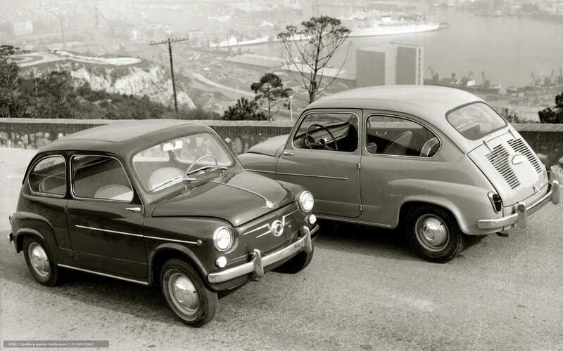 Two vintage Fiat cars on a hill