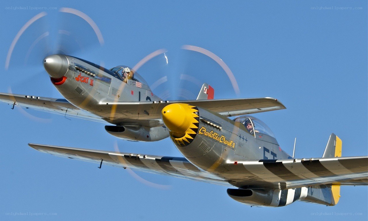 Two vintage fighter planes in flight
